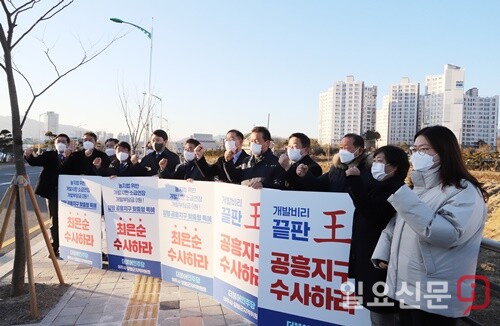 더불어민주당 경기도당 박정 위원장 등이 공흥지구 아파트(사진 뒤) 인근에서 ‘최은순 수사하라’ 는 등의 손팻말을 들고 특혜의혹 수사를 촉구했다.