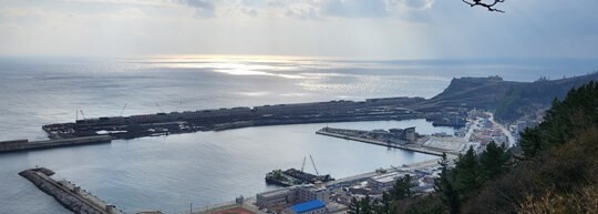 지난 12월 17일 울릉공항 인근 야산에서 내려다 본 울릉공항 공사 현장.  오른쪽에 있는 가두봉(해발 198m)이 해상 매립을 위해 절취돼 있다. 사진=김지영 기자