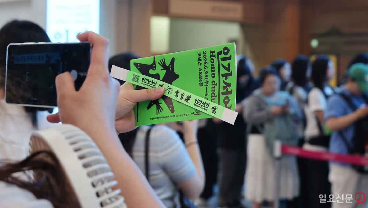 도서전 입장권과 안내책자를 들고 인증샷을 찍는 관람객. 사진=임준선 기자